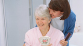 A woman is hugging an older lady