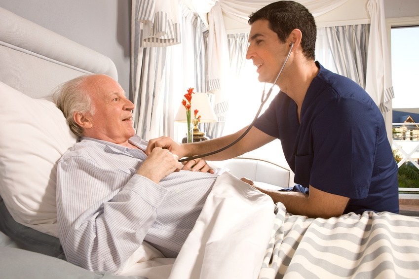 A man in blue shirt and white shirt holding hands with an older man.