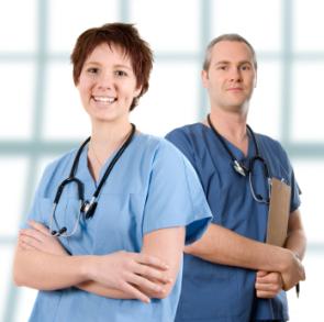 Two doctors standing in a hospital room with their arms crossed.