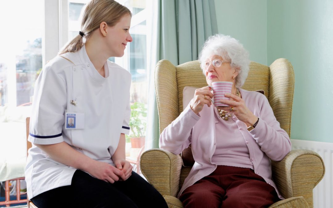 A woman sitting on the couch with an older person.