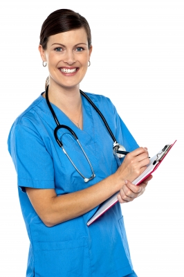A female doctor holding a clipboard and smiling.