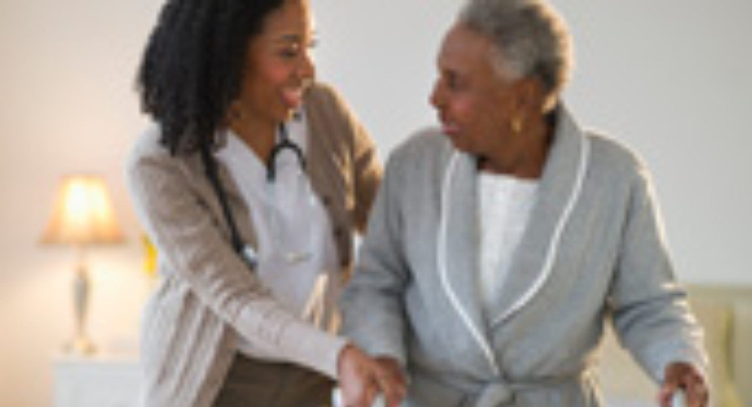 A woman and an older person shaking hands.