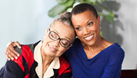 Two women are smiling for a picture.