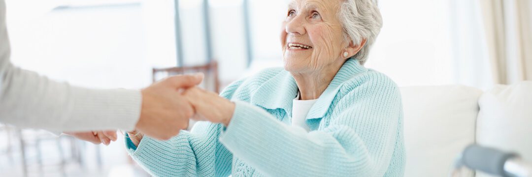 An older woman holding a hand out to someone.