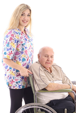 A woman standing next to an older man in a wheelchair.