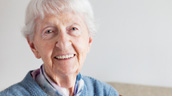 An older woman smiling for the camera.