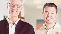 Two men standing next to each other in a room.