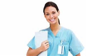 A nurse holding papers and smiling for the camera.