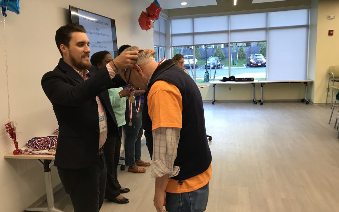 A man is getting his head shaved by another man.