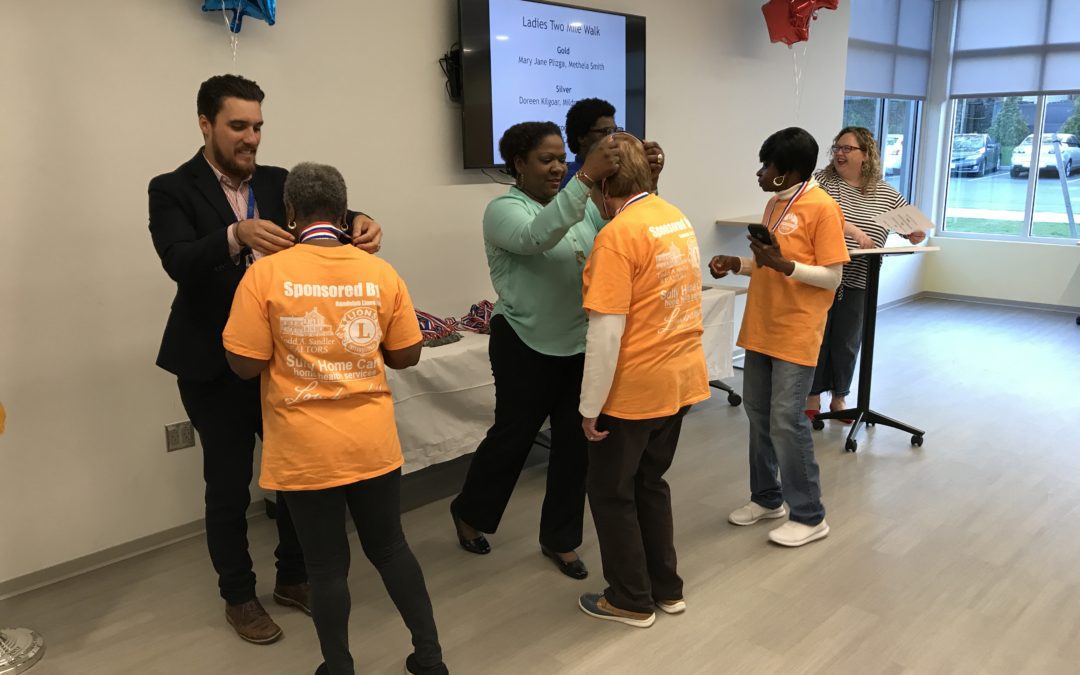 A group of people standing around each other.