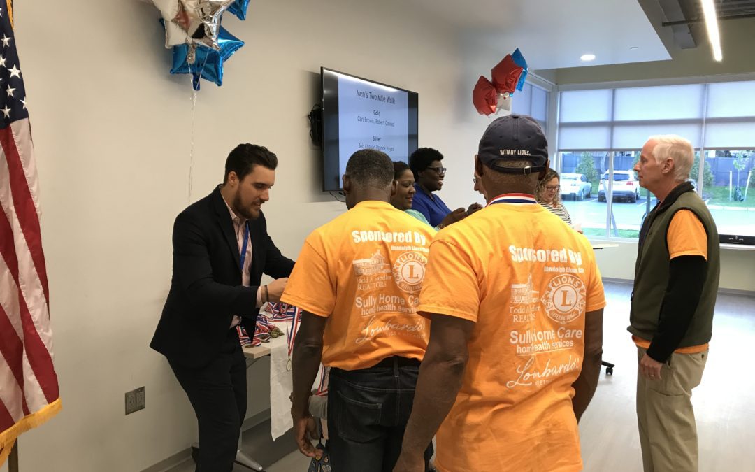 A group of people standing around in an office.