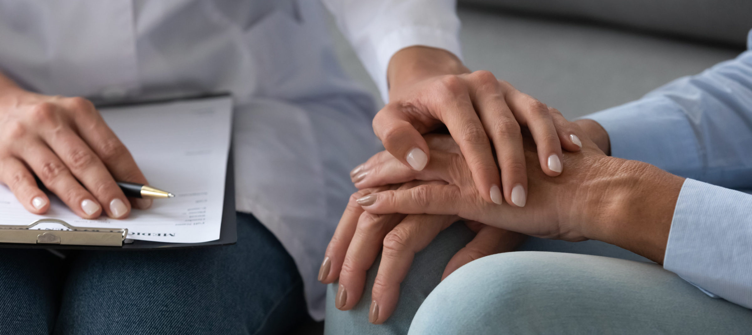 A person holding their hand over another persons arm.