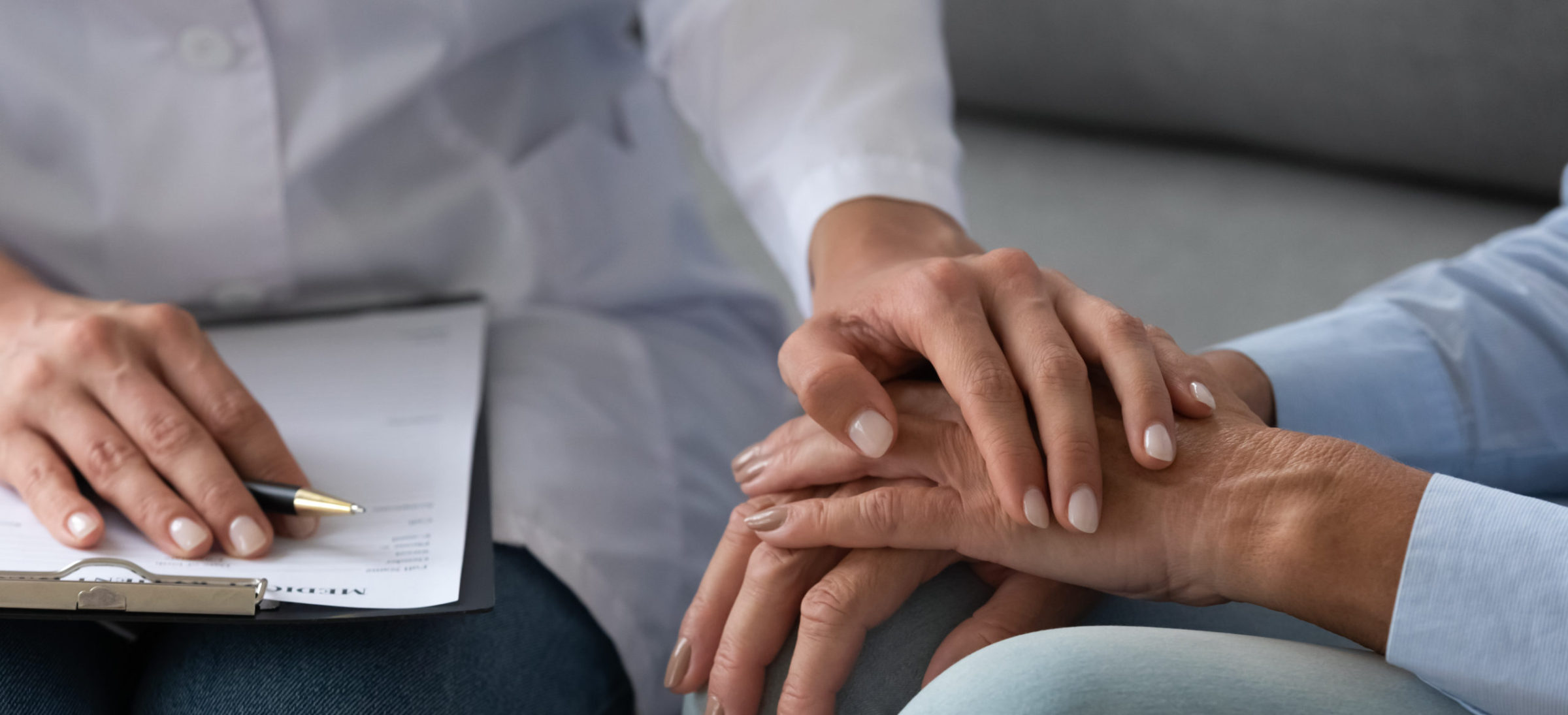 A person holding their hand over another persons arm.