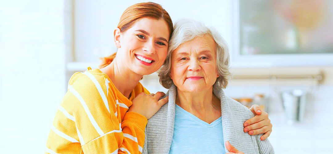 A woman and an older person smiling for the camera.